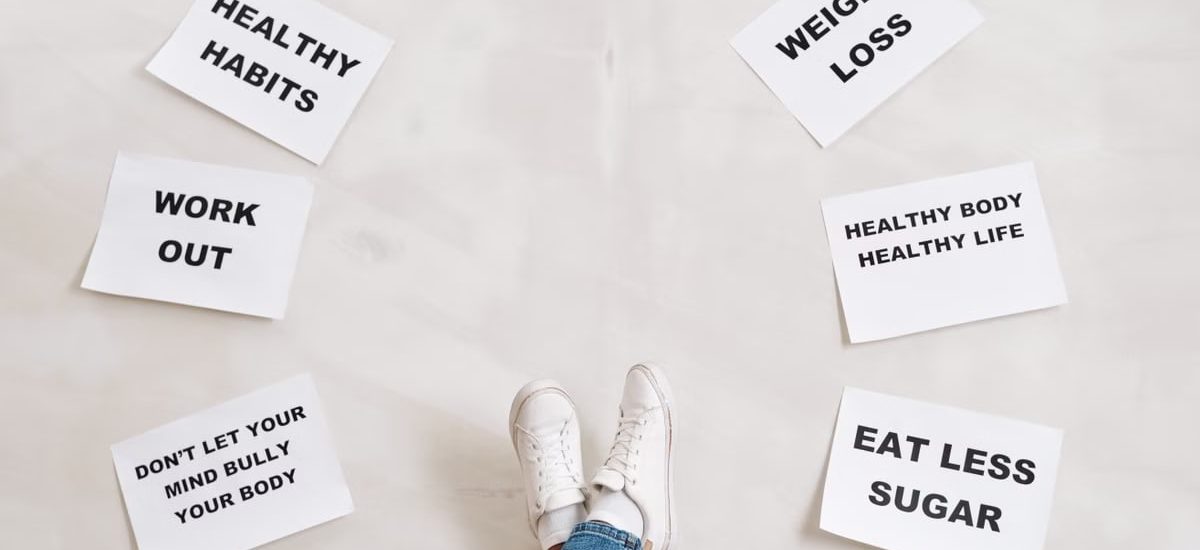 Inspirational health and fitness messages with shoe-clad feet, promoting healthy habits and wellbeing.